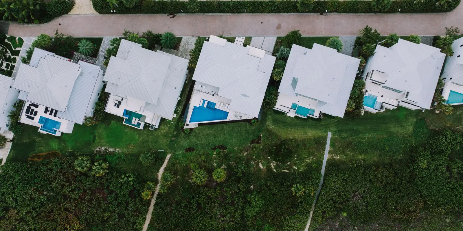Plumber in Doral: modern homes with pools seen from above