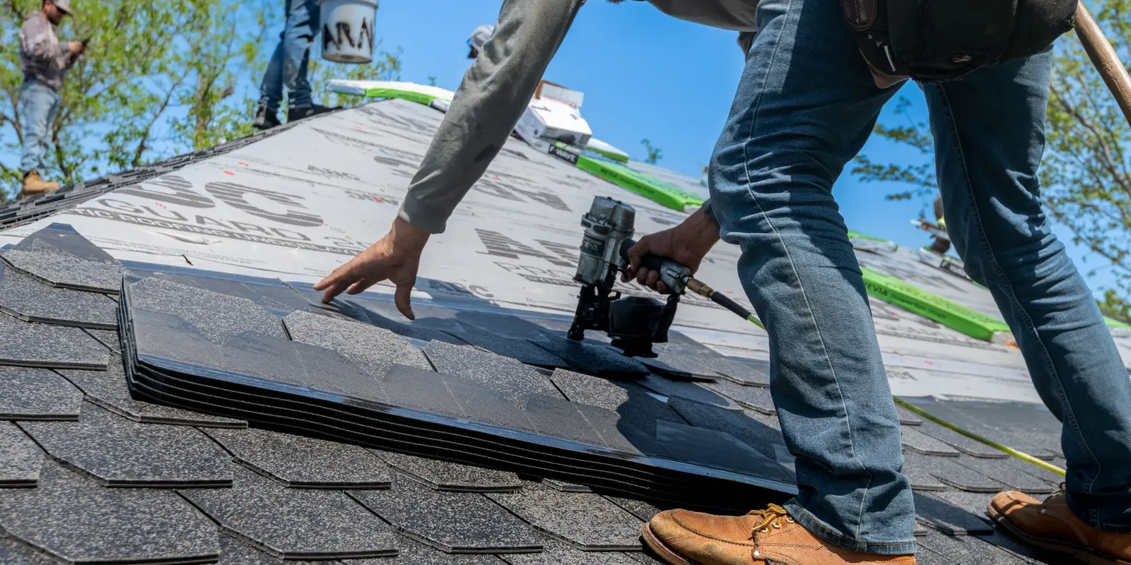 Roof repair in Miami: roofer fastening shingles